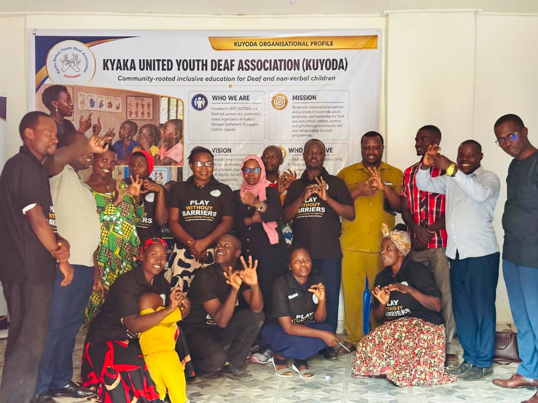 KUYODA In Visit — team and community members signing together