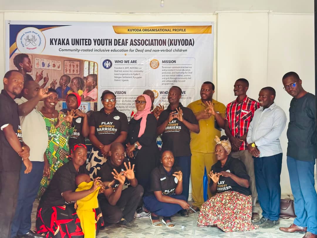 KUYODA In Visit — team and community members signing together
