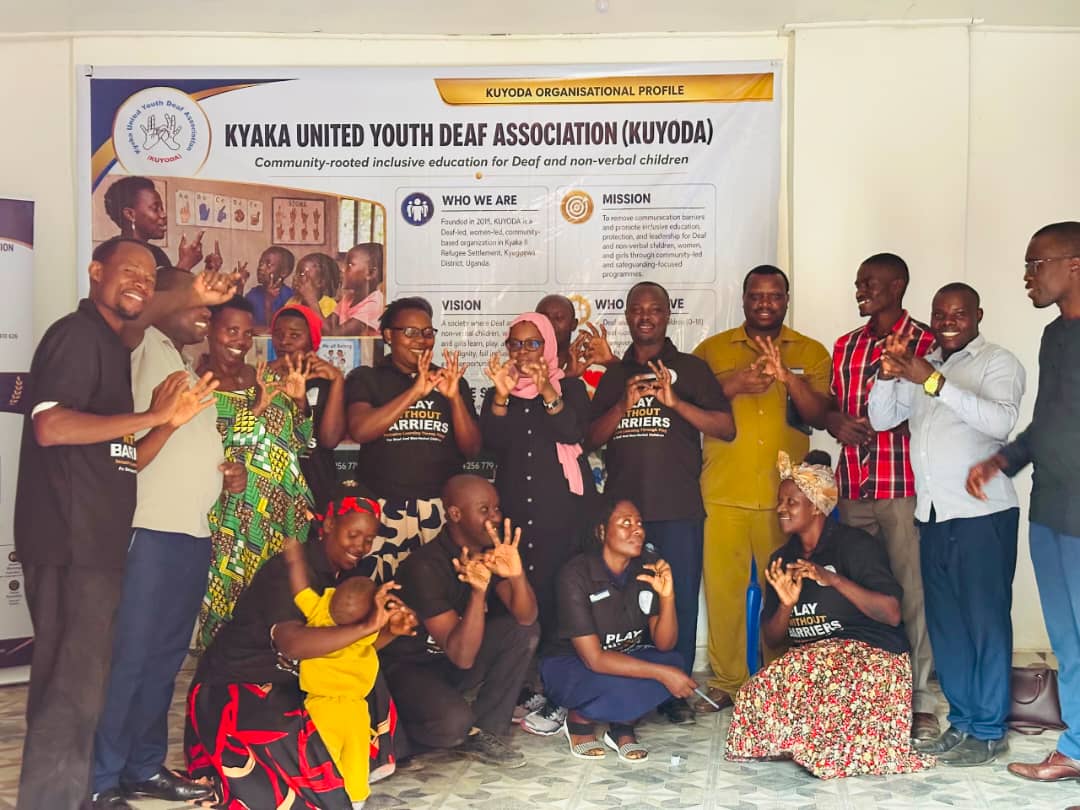 KUYODA In Visit — team and community members signing together