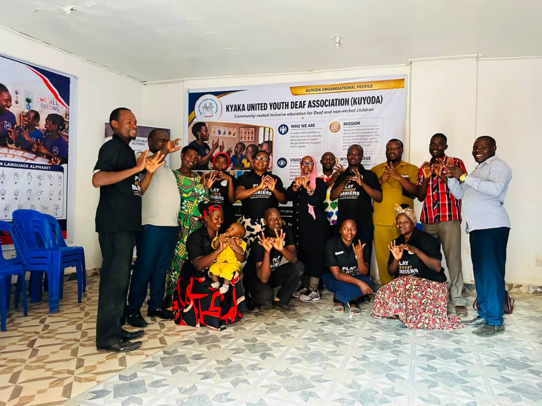 KUYODA In Visit — team and community members signing together